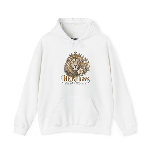 Lion of Judah — He Reigns Christian  Hoodie. A majestic crowned lion, delicate white lilies, and an ornate gold cross create an elegant declaration of faith. 